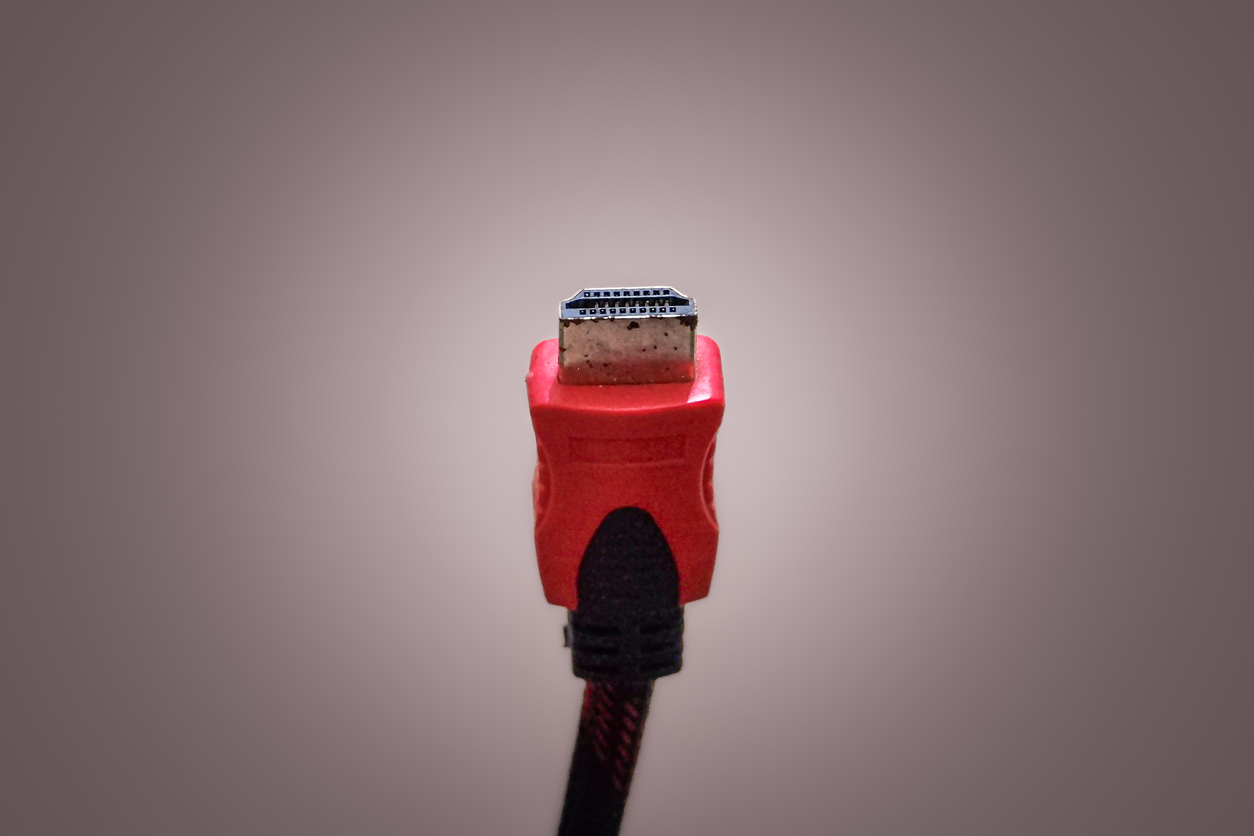 The image shows an HDMI cable isolated in front of a plain background to show the many benefits of hdmi fiber optic extenders.