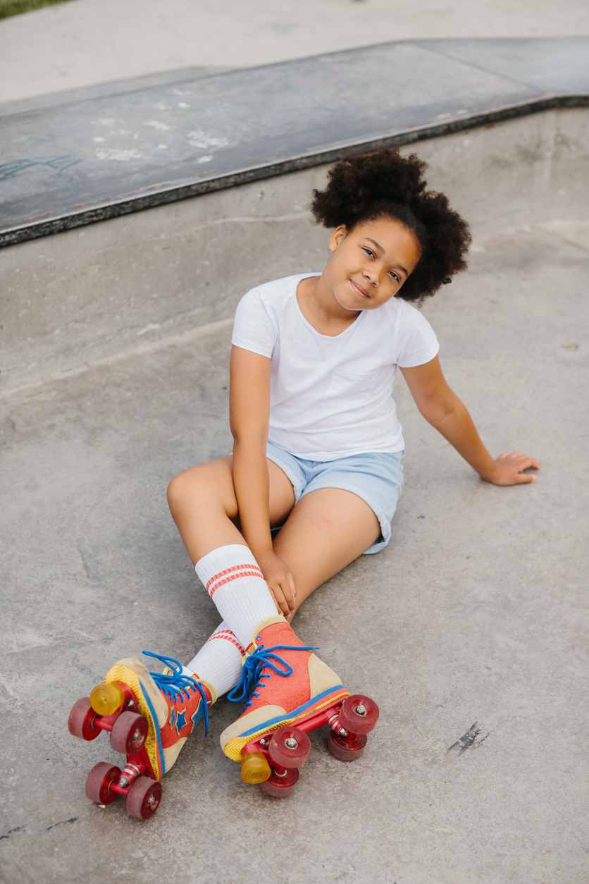 Cute little girl in retro roller skates as featured image for How Old Do You Need To Be To Roller Skate