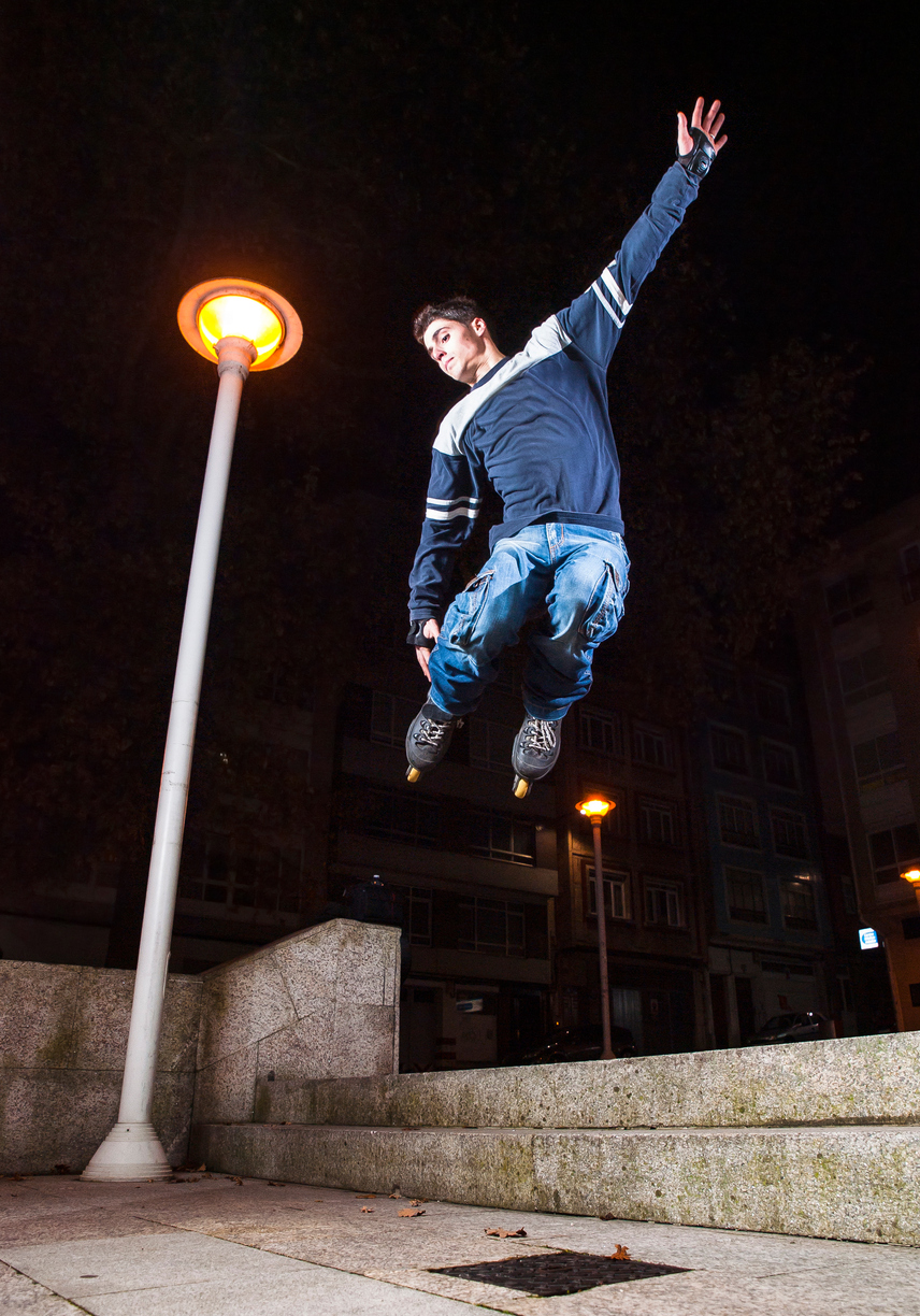 The image shows a man roller skating at night as the featured image for Safety Tips for Skating at Night