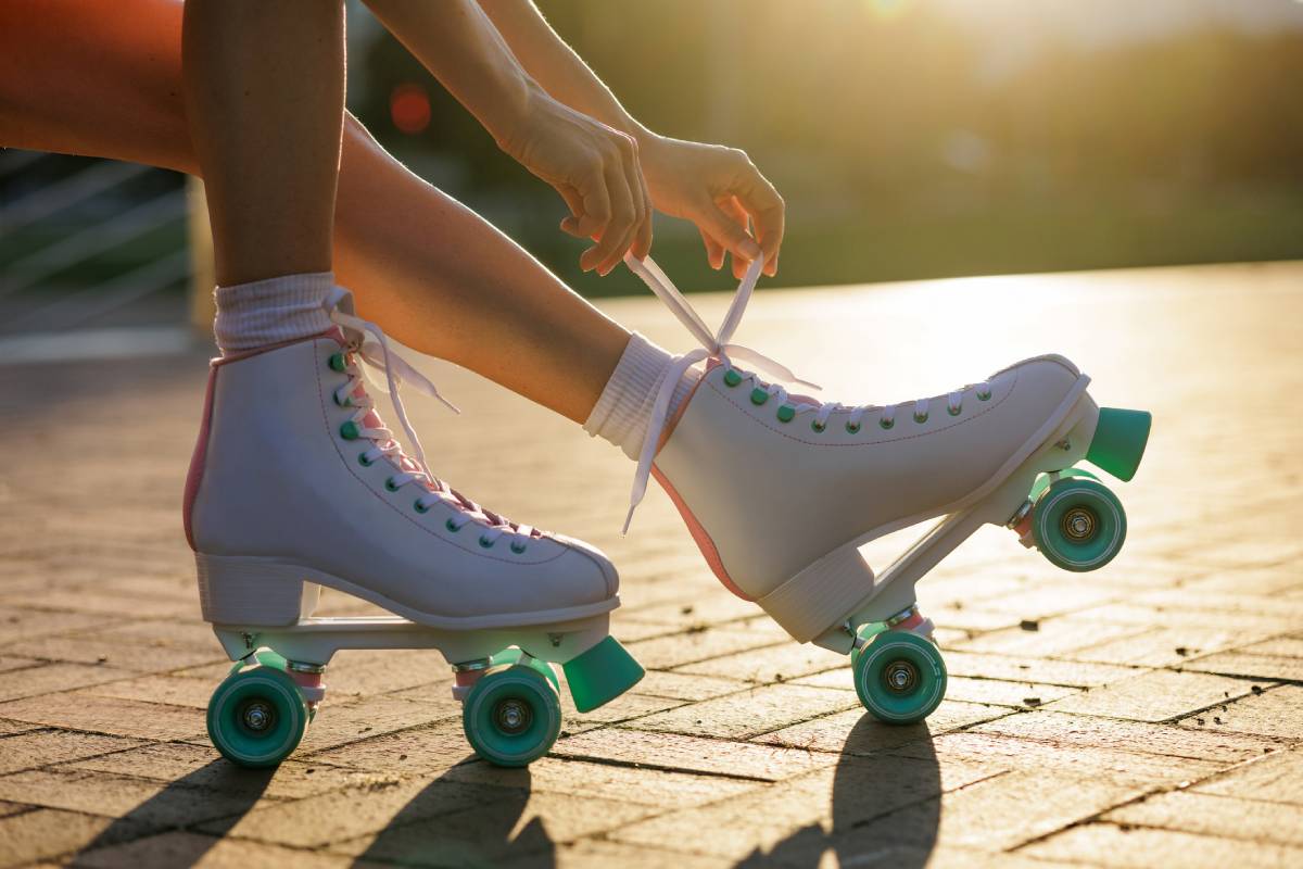 Woman lacing retro roller skates.