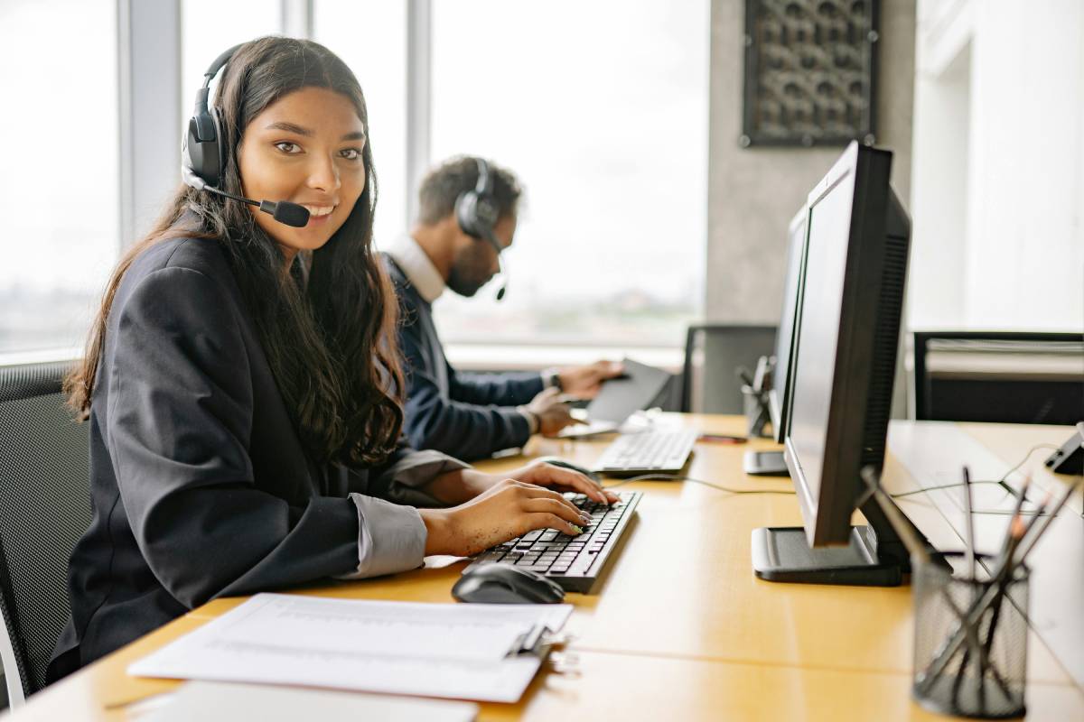 Woman helping client over the phone.