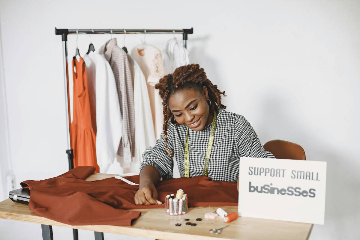 Small business owner sewing clothes.