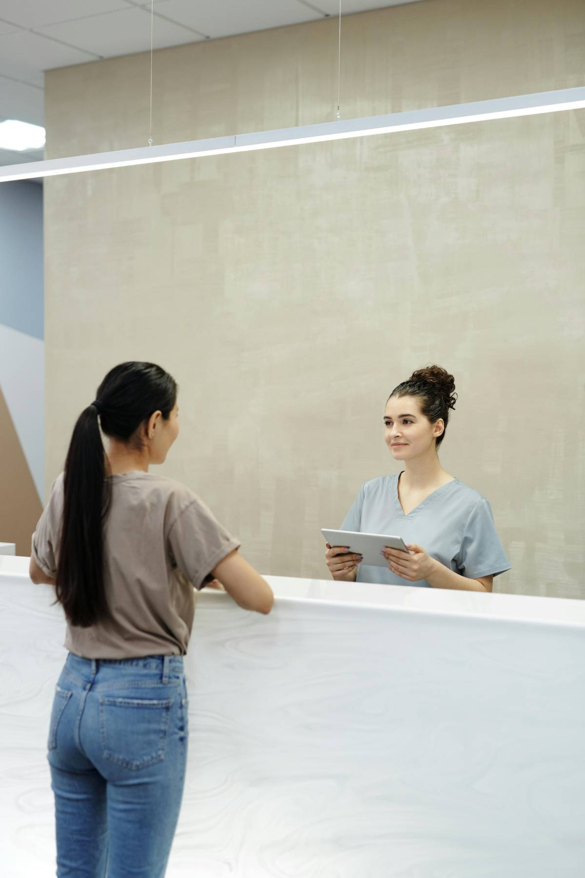 Hospital staff talking to a patient.